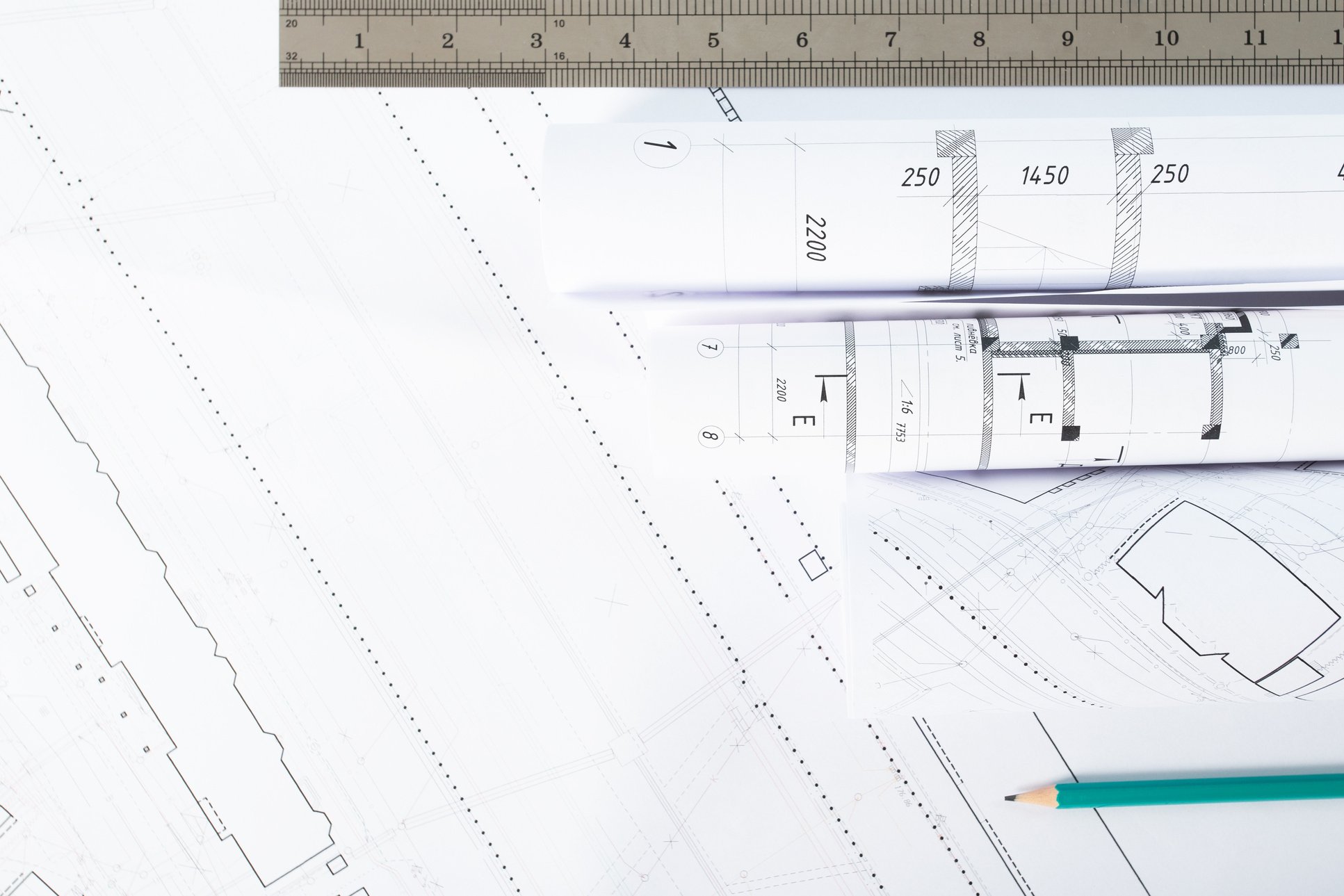 background of architectural blueprints and rolls with drawings